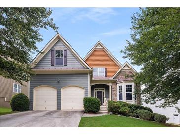 Charming two-story home featuring a two-car garage, stone accents, and well-manicured landscaping at 3610 Chestnut Meadows Dr, Douglasville, GA 30135
