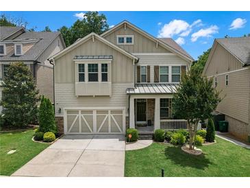Charming two-story home featuring a well-manicured lawn and a welcoming front porch at 1840 Tululah Trl, Smyrna, GA 30082