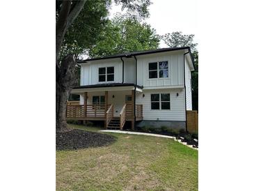 Charming two-story home with a cozy front porch and well-manicured lawn at 1962 Compton Se Dr, Atlanta, GA 30315