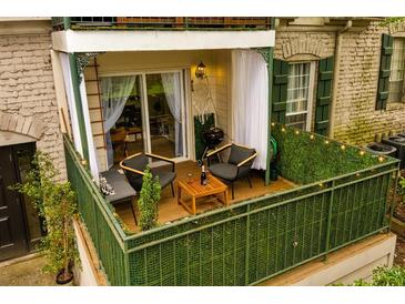 Relaxing patio with wood flooring, seating, and privacy greenery at 2805 Ne Expressway Ne # B 16, Atlanta, GA 30345