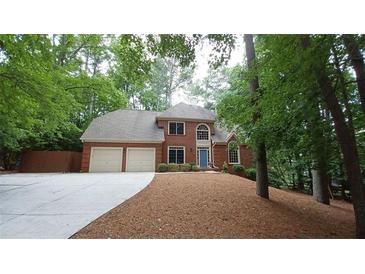 Charming two-story brick home featuring a two-car garage and a well-manicured front yard at 5190 Southlake Dr, Alpharetta, GA 30005