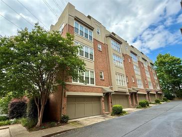 Attractive townhome exterior with brick facade, private garages, and manicured landscaping in a desirable neighborhood at 1376 Parkview Ne Ln, Atlanta, GA 30324