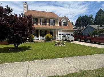Traditional two-story home featuring a well-manicured lawn and welcoming front porch at 2295 Eagle Pointe Ct, Lawrenceville, GA 30044
