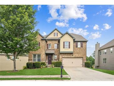 Charming two-story brick home with a well-manicured lawn and attached two-car garage at 2755 Evan Manor Ln, Cumming, GA 30041