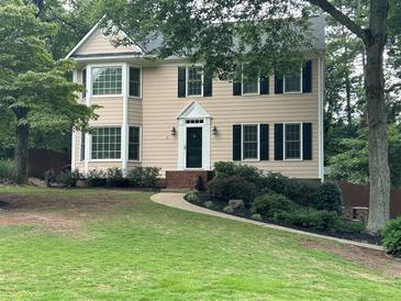 Charming two-story home with manicured lawn and classic design details like black shutters and bay windows at 3641 Bramblewood Way, Marietta, GA 30062