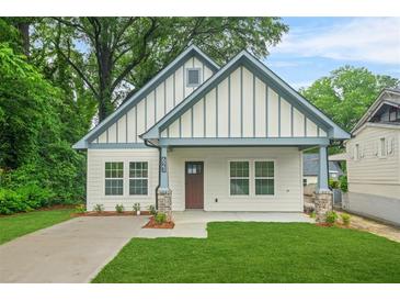 Charming exterior of a home featuring a manicured lawn and neutral paint scheme at 623 Hamilton E Holmes Nw Dr, Atlanta, GA 30318