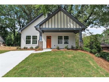 Charming home featuring a modern facade, complemented by a well-maintained lawn and an inviting, covered front porch at 623 Hamilton E Holmes Nw Dr, Atlanta, GA 30318