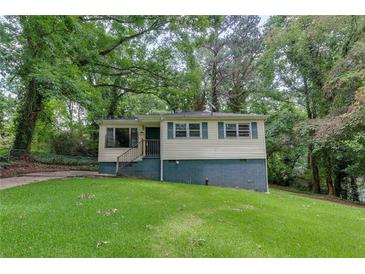 Charming home with a well-maintained lawn and mature trees at 629 Hickory Se Trl, Mableton, GA 30126
