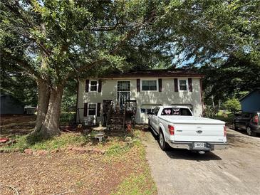 Charming two-story home with a cozy front yard and inviting curb appeal at 135 Woodcrest Dr, Covington, GA 30016