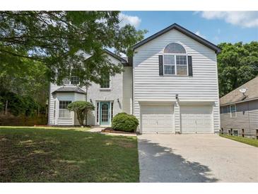 Charming two-story home with a well-maintained lawn and a two-car garage at 1025 Pebble Creek Trl, Suwanee, GA 30024