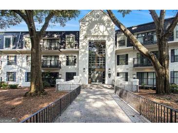 Elegant condo building featuring a striking entrance, balconies, and well-maintained landscaping at 2119 Pine Heights Ne Dr, Atlanta, GA 30324