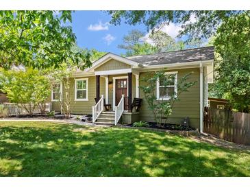 Charming craftsman home featuring an inviting entryway, mature trees, and well manicured lawn at 1734 8Th St, Brookhaven, GA 30341