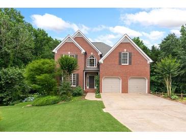 Charming two-story brick home with well-manicured lawn and mature trees at 4987 Day Lily Nw Way, Acworth, GA 30102
