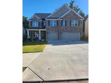 Beautiful brick two-story home with well-manicured lawn and spacious driveway at 3675 Brookhollow Dr, Douglasville, GA 30135