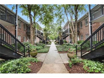 Beautifully landscaped condo community with brick buildings and meticulously maintained grounds at 3675 Peachtree Ne Rd # 24, Atlanta, GA 30319
