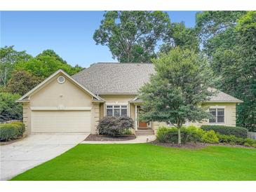 Charming ranch-style home featuring a two-car garage, manicured lawn, and mature trees, perfect for suburban living at 2676 Varner Ne Dr, Atlanta, GA 30345