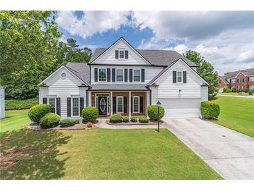 Charming two-story home featuring a well-manicured lawn and traditional design elements at 3906 Elm Trace Ct, Loganville, GA 30052