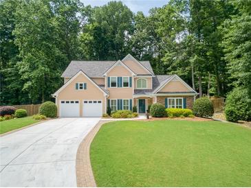 Charming two-story home with a well-manicured lawn and a two-car garage at 4204 Woodfare Nw Ln, Kennesaw, GA 30152