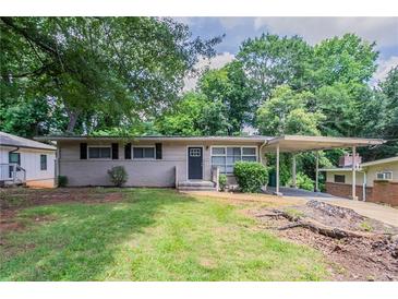 Charming single story home with a carport and well-manicured front yard at 1538 Belva Ave, Decatur, GA 30032