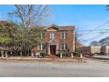 Charming brick multi-Gathering home featuring a traditional design with a manicured front yard and mature trees at 733 Frederica Ne St # 7, Atlanta, GA 30306