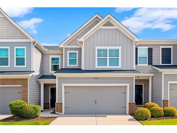 Charming townhome featuring a large garage, neutral siding, and manicured landscaping at 804 Whittington Sw Pkwy, Marietta, GA 30060