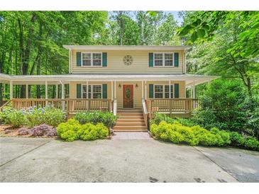 Charming two-story home featuring a large front porch and lush landscaping at 4211 Burnt Hickory Nw Rd, Marietta, GA 30064