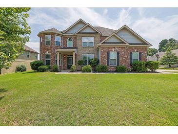Charming brick two-story home with a well-manicured lawn and a welcoming front entrance at 4315 Balsam Bark Dr, Cumming, GA 30028