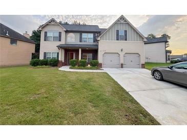 Charming two-story home with a well-manicured lawn and inviting curb appeal at 3429 Lake End Dr, Loganville, GA 30052