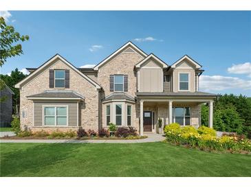 Charming two-story brick home with a well-manicured lawn and colorful landscaping at 4090 Sierra Knolls Ct, Cumming, GA 30040
