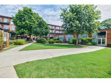 A beautiful condo building with well-manicured landscaping and lush green lawn at 5200 Peachtree Rd # 1104, Atlanta, GA 30341