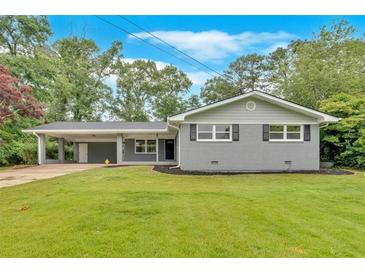 Charming single-story home with grey brick and a well-manicured lawn at 4477 Timber Ridge Dr, Douglasville, GA 30135
