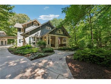 Stunning two-story home with lush landscaping, flag, and inviting front porch perfect for enjoying the outdoors at 508 Hastings Dr, Peachtree City, GA 30269