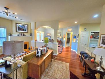 Spacious living room with hardwood floors, fireplace, and large windows that bring in a lot of natural light at 1349 Orchard Park Dr, Stone Mountain, GA 30083