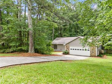 Charming single-story home with a lush, tree-filled yard and attached two-car garage at 845 Creek Trail Northwest Nw Trl, Kennesaw, GA 30144