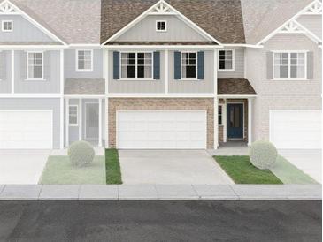 Charming two-story home with a brick facade, two-car garage, and a manicured front lawn at 346 Lanier Cir, Woodstock, GA 30189