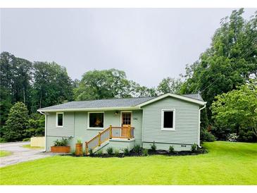 Charming cottage-style home featuring a freshly painted exterior and manicured lawn at 1042 Oakdale Se Dr, Smyrna, GA 30080