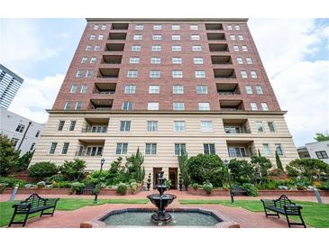 Beautiful brick apartment building with manicured landscaping and a water fountain in the front at 3657 Peachtree Ne Rd # 4A, Atlanta, GA 30319