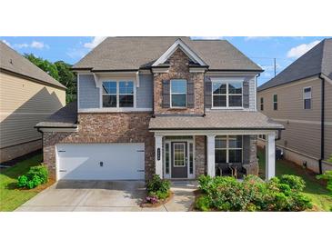 Charming two-story home with a brick facade and inviting front porch at 3860 Oxford Park Ln, Cumming, GA 30040
