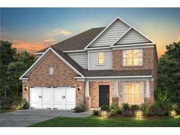 Charming two-story brick home with white trim, landscaped yard, and a two-car garage at 5110 Mulberry Pass Ct, Hoschton, GA 30548