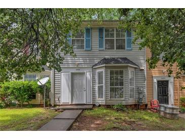 Charming townhome featuring blue shutters and well-maintained landscaping in a desirable neighborhood at 5618 Stonington Trace Pkwy, Stone Mountain, GA 30087