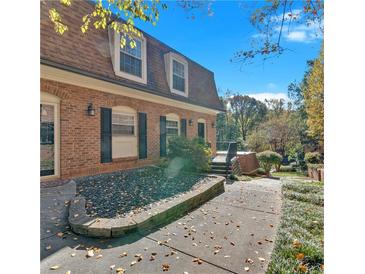 Charming two-story home features a brick facade, manicured landscaping, and inviting entrance at 1261 Lavista Ne Rd # E-8, Atlanta, GA 30324