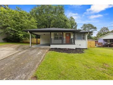 Charming renovated home with a covered carport and inviting front porch at 1553 Mccallie Nw Blvd, Atlanta, GA 30318