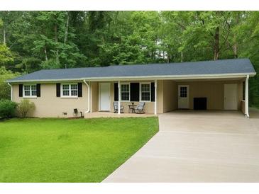 Charming single-story home with manicured lawn, black shutters, and covered parking in a lush setting at 3854 Bright Star Road, Douglasville, GA 30135
