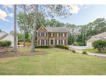 Charming brick-front home with a spacious front yard and mature trees, offering great curb appeal at 2056 Plantation Rd, Lawrenceville, GA 30044