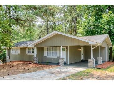 Charming single-story home with a covered carport and a well-maintained front yard at 2279 Hickory Grove Nw Rd, Acworth, GA 30101