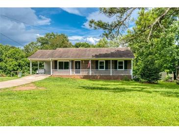 Charming single-story home with a covered porch and well-maintained front yard at 1997 Villa Rica Hwy, Dallas, GA 30157