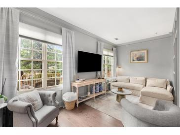 Bright living room featuring hardwood floors, large windows, and elegant furnishings at 1055 Piedmont Ne Ave # 106, Atlanta, GA 30309
