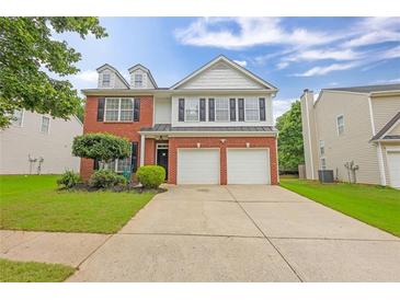 Charming two-story home with a brick facade, two-car garage, and well-maintained landscaping at 2011 Wildcat Lake Ct, Lawrenceville, GA 30043