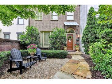 Charming brick townhome with a beautifully landscaped front yard and cozy seating area at 3163 Neal Ct, Cumming, GA 30041