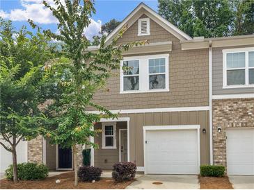Charming townhome with attached garage, neat landscaping, and neutral colored siding in an attractive neighborhood at 3135 Journal Ct, Decatur, GA 30035